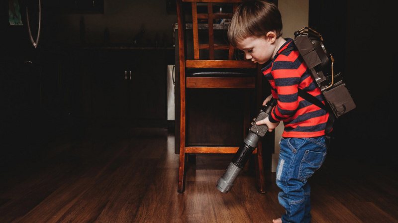 kid vaccuming the floor