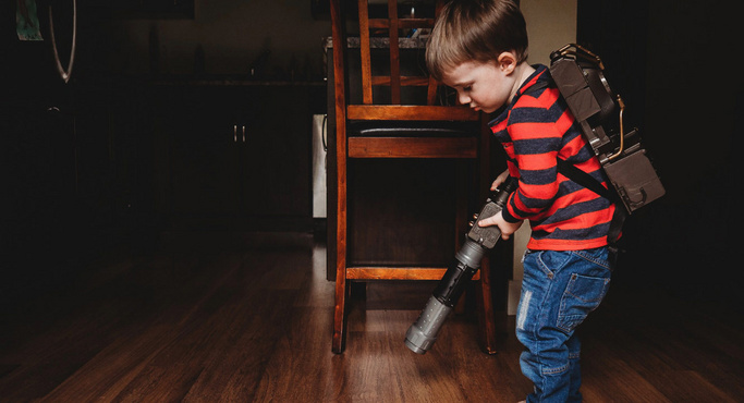 kid vaccuming the floor