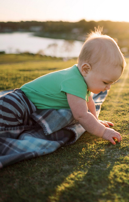 baby playing in grass small