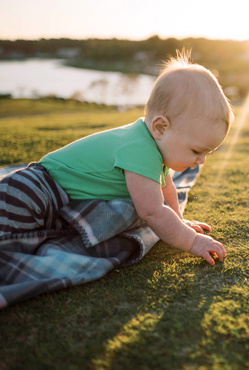 baby playing in grass small