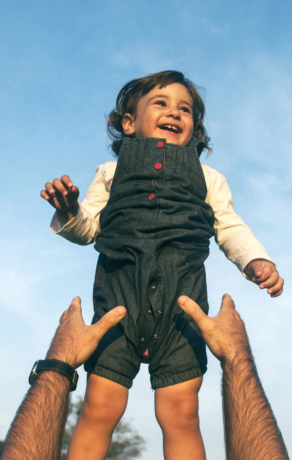 dad throwing his kid up in the air 