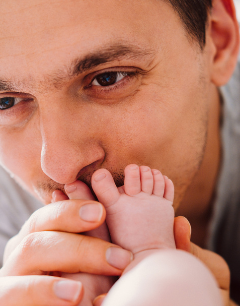 happy young father looking with tenderness at his baby 