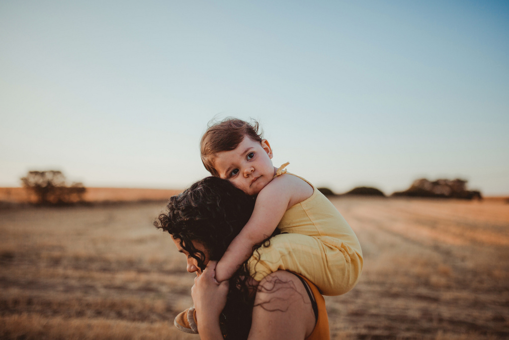 sad baby on moms shoulders