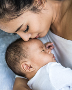 baby sleeping calmly beside mommy 