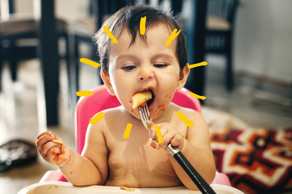 cute baby eating pasta with fork with sunshine