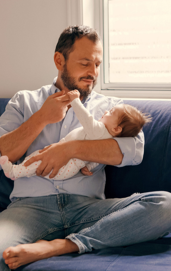 baby holding dads finger