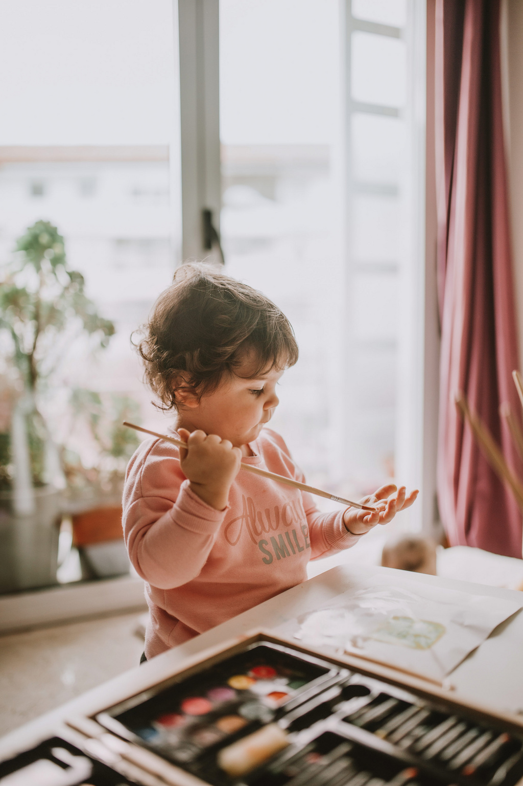 toddler with paintbrush